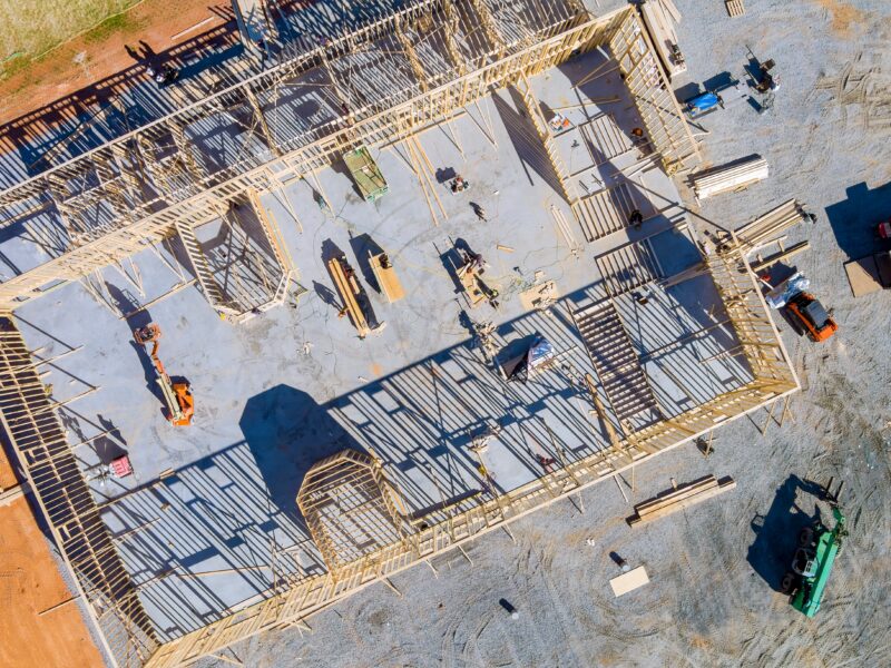 Top aerial view new framing stick built building of beams on new home under construction